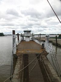 Pier on railroad track against sky