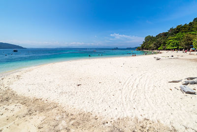 Scenic view of beach against blue sky