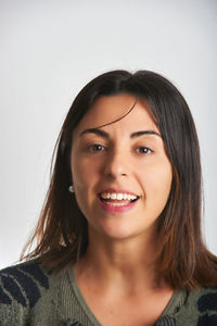 Close-up of young woman against white background