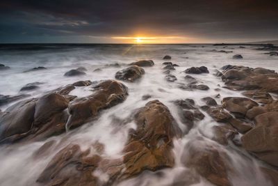 Scenic view of sea against sky during sunset