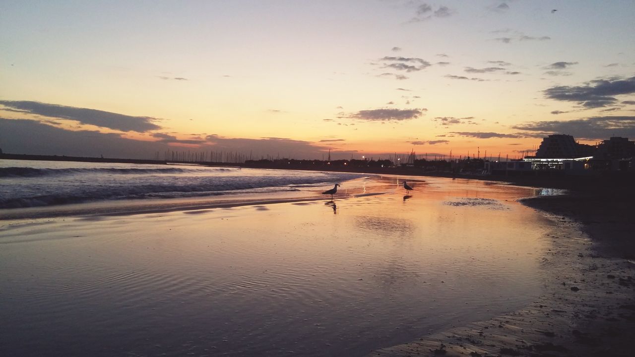 beach, water, sea, sunset, sand, shore, sky, scenics, tranquil scene, tranquility, beauty in nature, nature, coastline, idyllic, incidental people, reflection, wave, dusk, horizon over water, outdoors