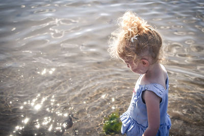 Girl standing by sea