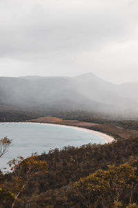 Scenic view of lake and mountains against sky