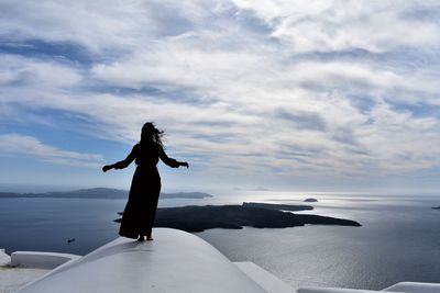 Man standing on beach against sky