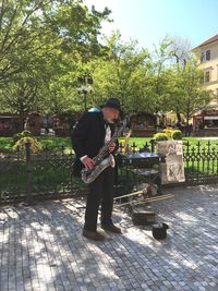 Man standing by tree