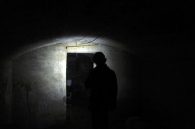 Rear view of woman standing in tunnel