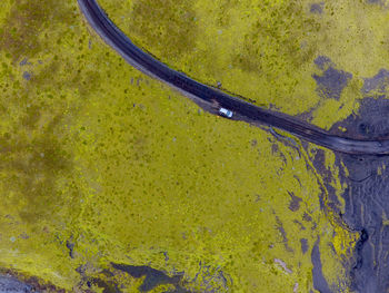 Aerial view of car on road amidst green landscape