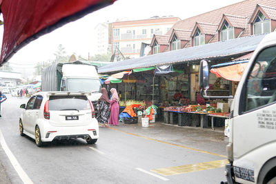 Vehicles on road along buildings