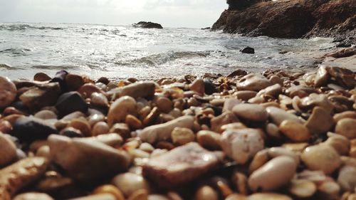 Rocks on beach against sky