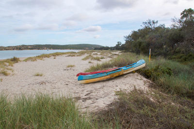 Boat on shore against sky