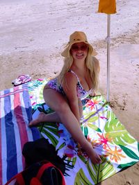 Portrait of smiling young woman sitting outdoors