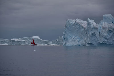 Sailboat in sea against sky