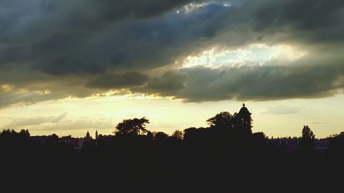 Silhouette of landscape against cloudy sky