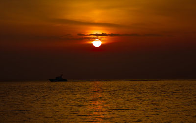 Scenic view of sea against orange sky