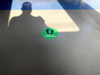 High angle view of person with shadow on the background