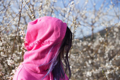 Portrait of woman with pink umbrella against trees during winter