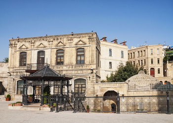 Exterior of old building against clear blue sky