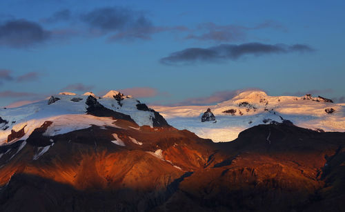 Scenic view of snowcapped mountains against sky during sunset