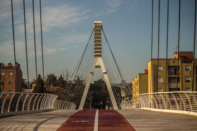 View of bridge and buildings against sky