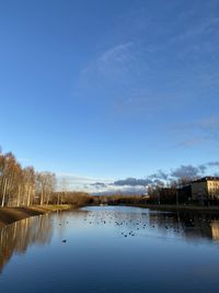 Scenic view of lake against blue sky