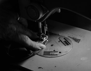 Close-up of hand on sewing machine