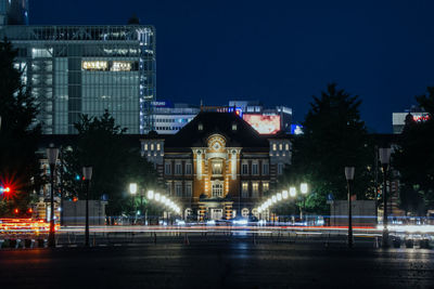 Illuminated buildings against sky at night