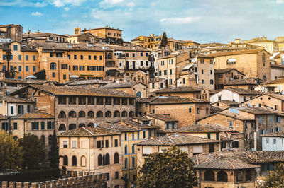 Buildings in town against sky