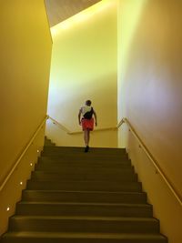 Low angle view of man walking on stairs