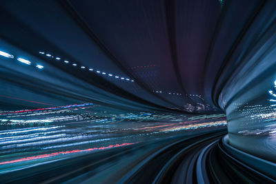 Light trails on illuminated tunnel at night