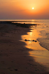 Scenic view of beach against sky during sunset