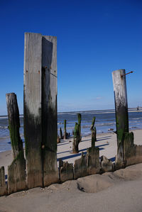 Scenic view of beach against clear blue sky