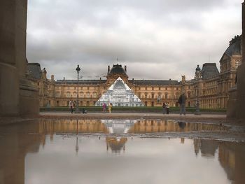 Buildings against cloudy sky