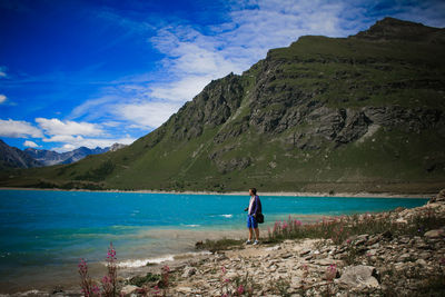 Man standing at lakeshore