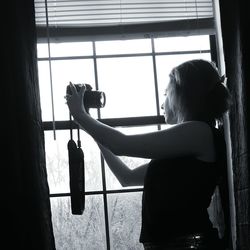 Woman looking through window