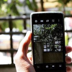 Close-up of cropped hand holding smart phone