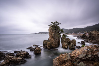 Panoramic view of rocks on the beach against sky