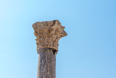 Low angle view of sculpture against clear blue sky