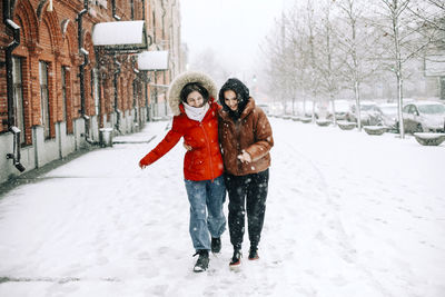 Full length of woman on snow covered trees