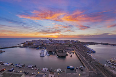 High angle view of boats in sea against cloudy sky