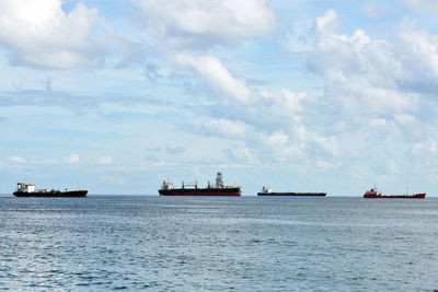 Boats on sea against sky