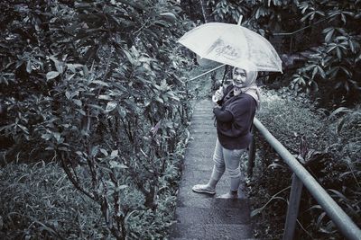 Woman with umbrella walking in rain