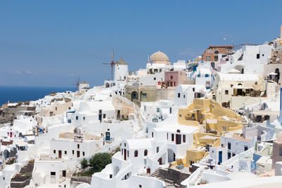 Buildings against clear sky on sunny day