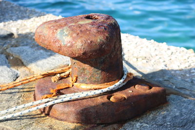 Close-up of rusty metal on sea shore