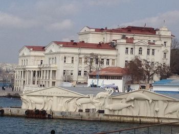 Buildings by swimming pool in city