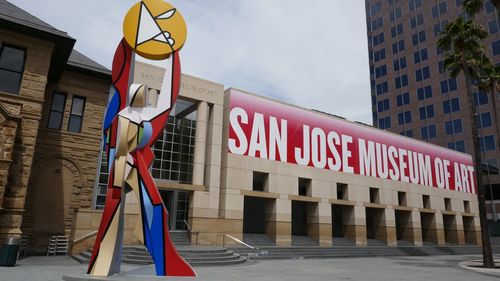 Low angle view of road sign against buildings in city