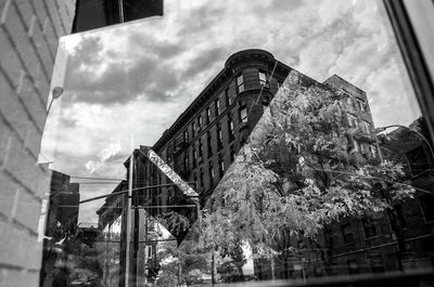 Low angle view of building against cloudy sky