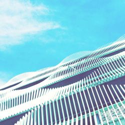 Low angle view of modern building against blue sky