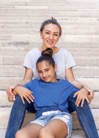 Portrait of boy sitting on staircase