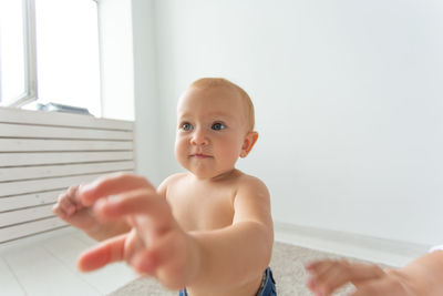 Portrait of shirtless boy at home