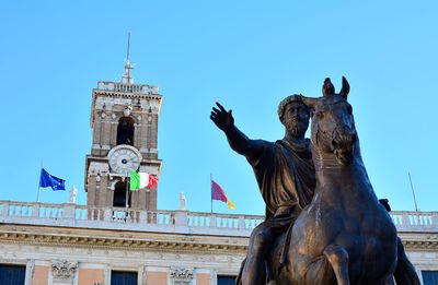 Low angle view of statue of building against clear sky